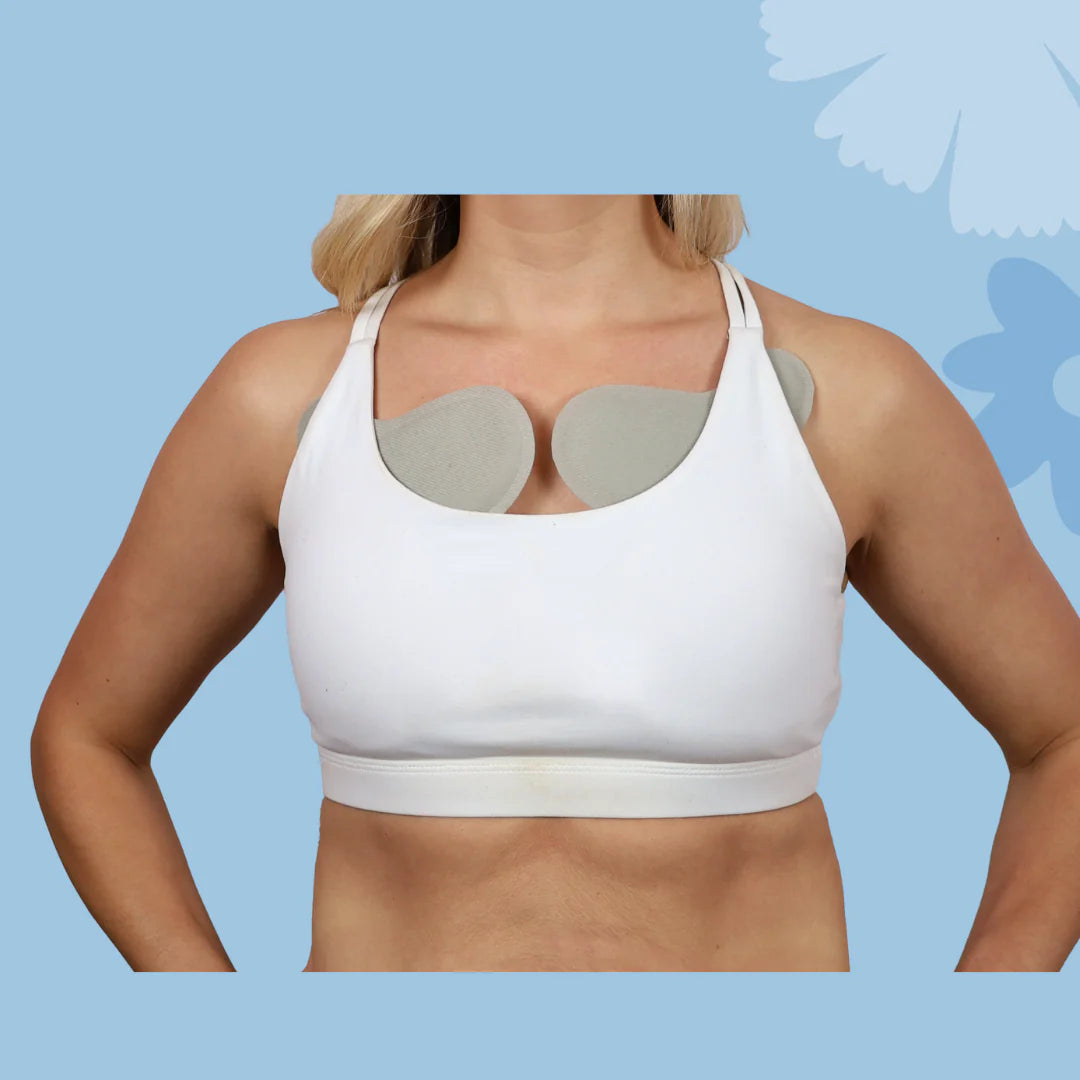 Woman using Keep Me Cool by Issviva includes soft, reusable cooling bra inserts designed to soothe hot flushes and provide all-day comfort.