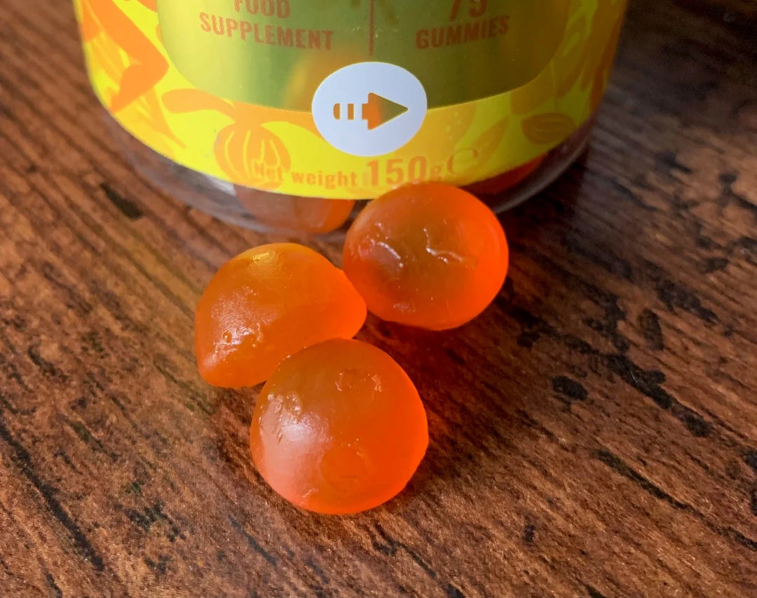 Gummies of Issviva Mood & Energy Food Supplement bottle with bright orange label, featuring citrus illustrations